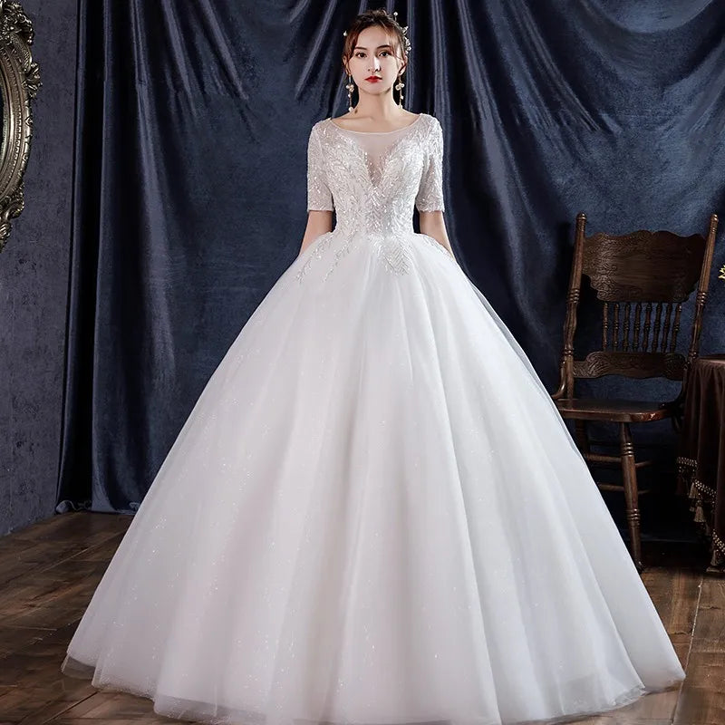 فستان زفاف بأكمام قصيرة كلاسيكي مزين بالترتر وأربطة على شكل كرة الأميرة الفاخرة فيستدو دي نويفا رداء دي ماري