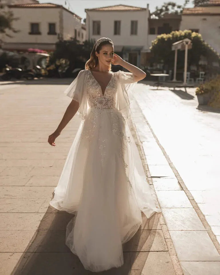 Romantic A-Line Bridal Dress with Bell Sleeves, Illusion Neckline, Glitter Embellishments, and Natural Waistline Satin