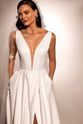 Sophisticated A-Line Wedding Gown with Deep Neckline, Sleeveless Design, and Button Embellishments Satin