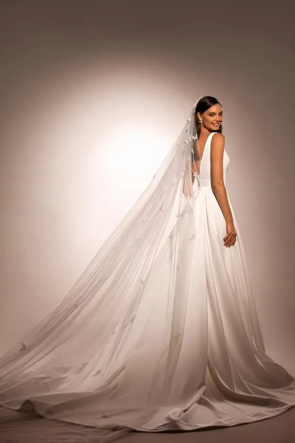 Sophisticated A-Line Wedding Gown with Deep Neckline, Sleeveless Design, and Button Embellishments Satin
