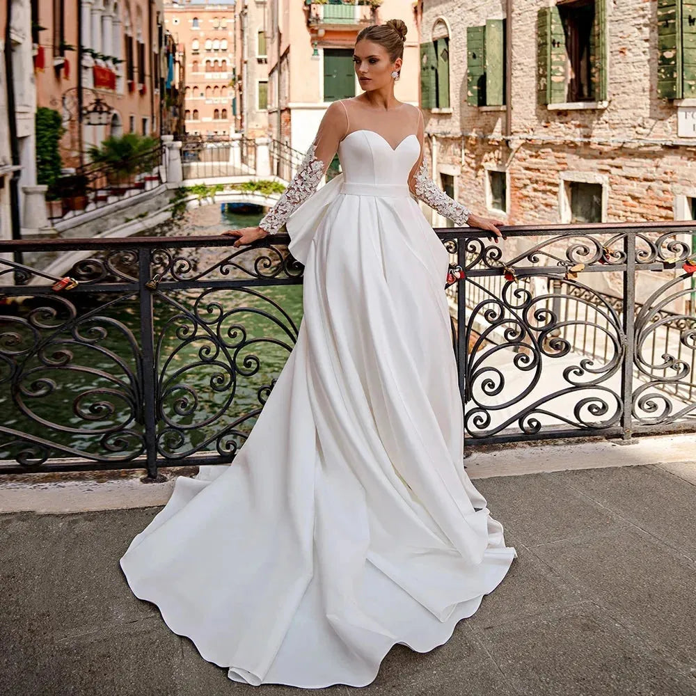 Elegant Satin Wedding Dress for Bride Sheer Long Sleeves Round Neck Applique Back Big Bow Corset Bridal Gown A Line Design Ivory 22w